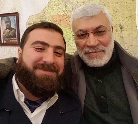 ريان الكلداني يحتضنه أبو مهدي المهندس، أحد أبرز قادة الميليشيات الموالية لإيران في العراق. قُتل الكلداني في غارة أمريكية بطائرة مسيرة مع الجنرال قاسم سليماني، قائد فيلق القدس في الحرس الثوري الإيراني، في يناير/كانون الثاني 2020.
